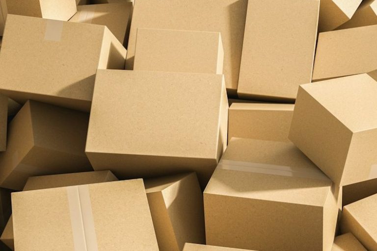 A pile of stacked brown cardboard boxes of various sizes.