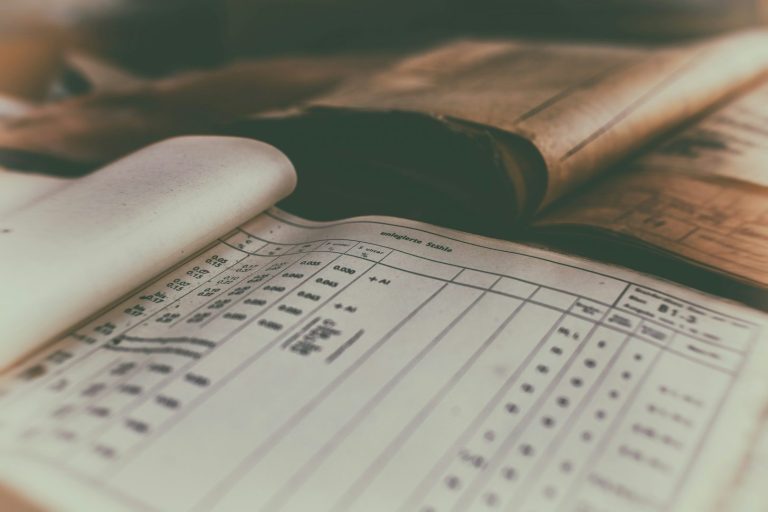 Opened vintage ledger displaying handwritten entries and lined pages.